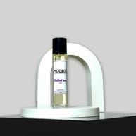 A bottle of '010 - Inspired by Creed Aventus' cologne on a white stand against a grey background.
